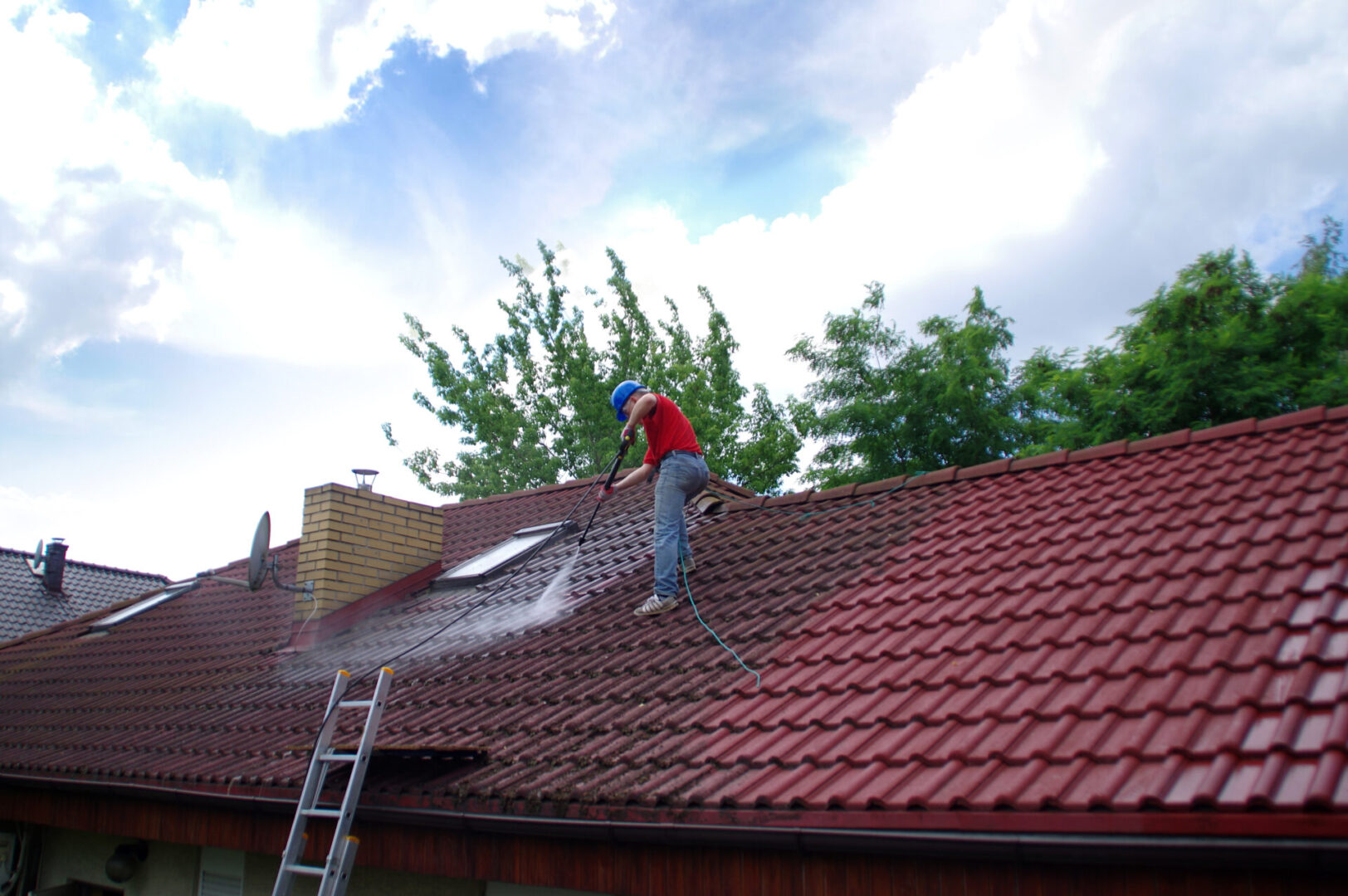 Roof maintenance using pressure washer