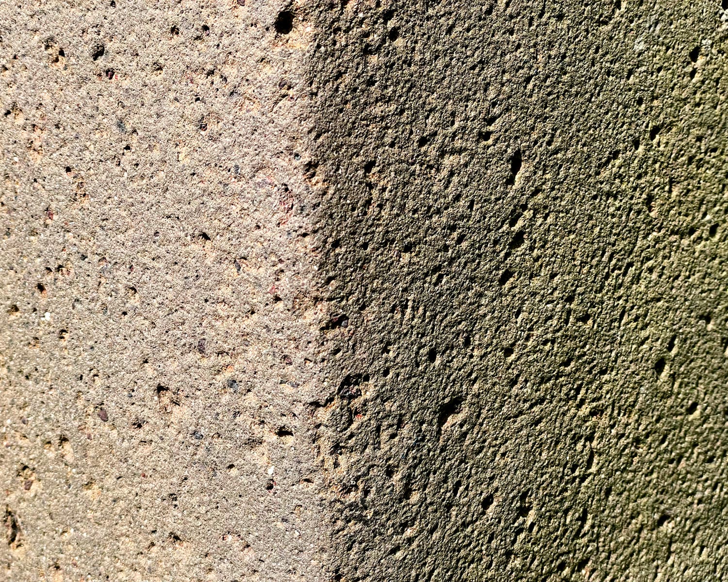 Close-up of rough concrete wall with shadow