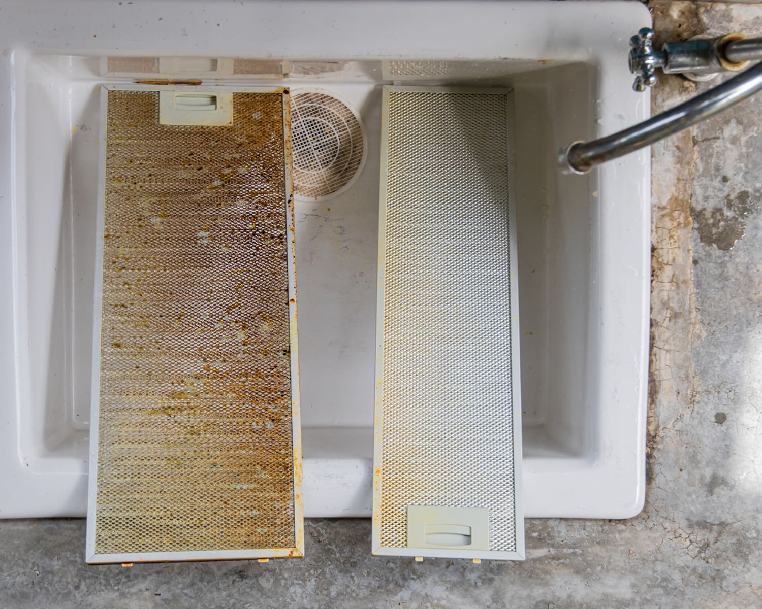 Dirty and clean range hood filters in sink