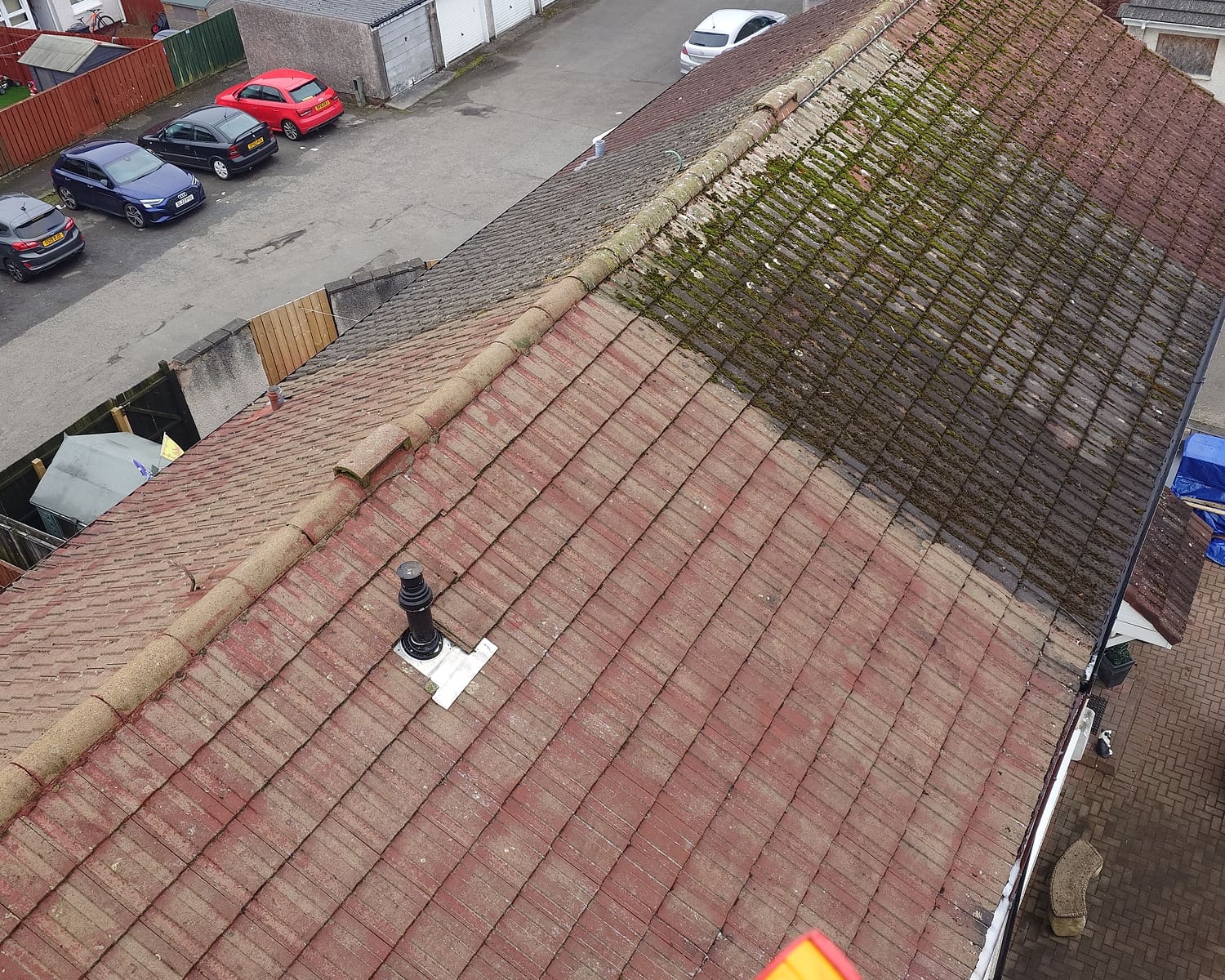 Aerial view of mossy red tiled roof